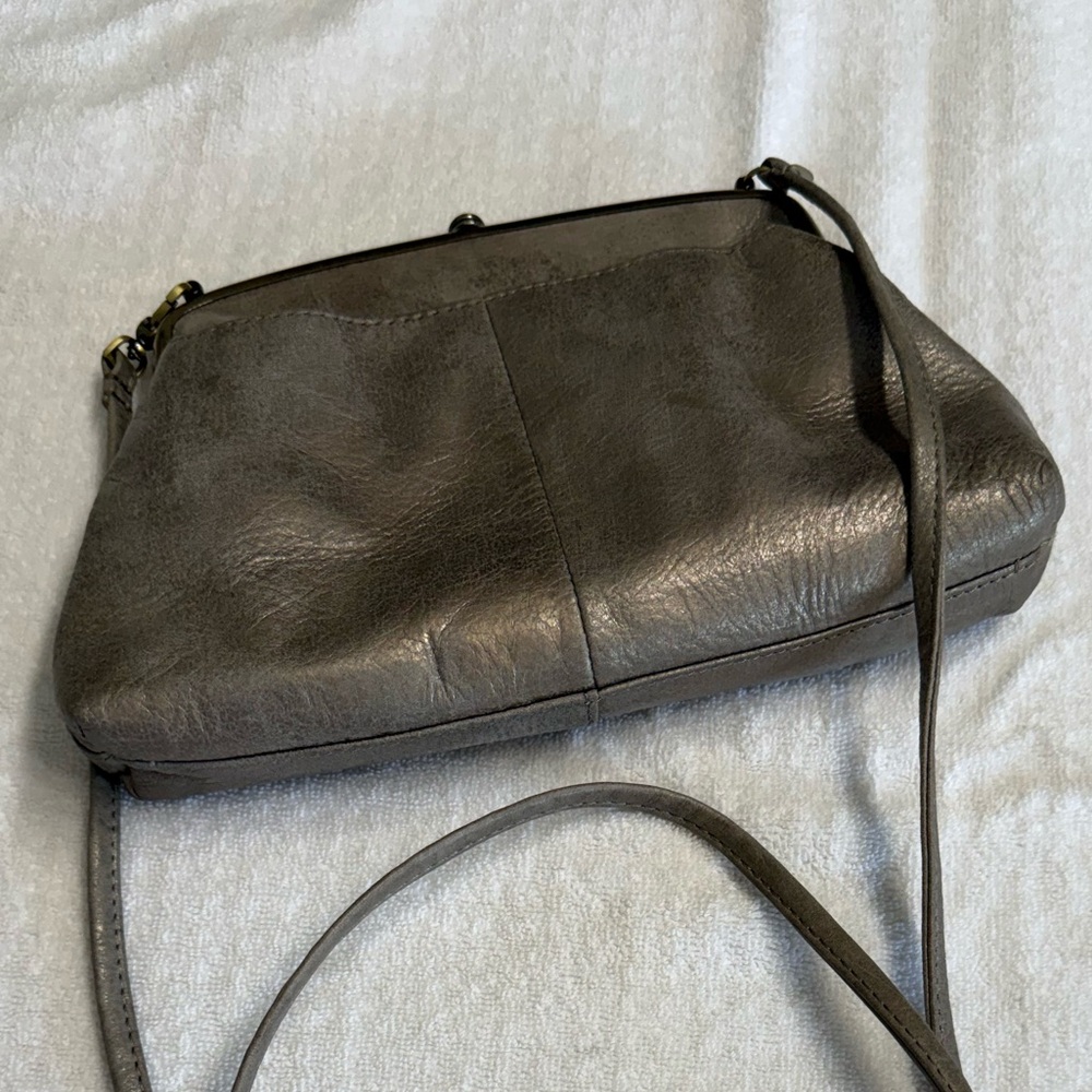 Hobo Lana crossbody bag in metallic. Kiss lock brushed gold hardware.